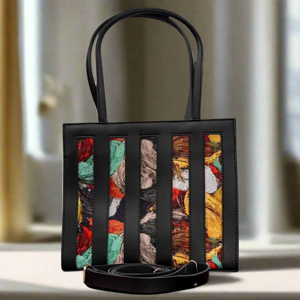 Black handbag with colorful striped pattern on a light background